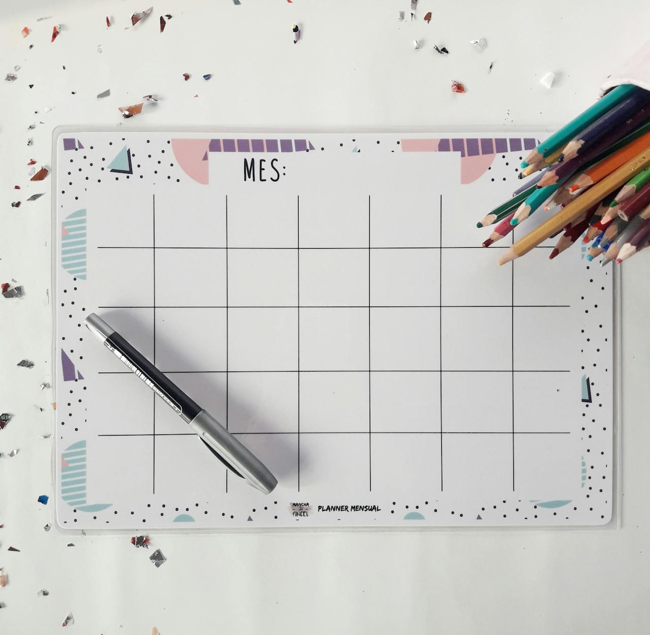 Mastering the First Impression: Your intriguing post title goes here Top view of a monthly planner with a pen and colored pencils, perfect for organizing your schedule.