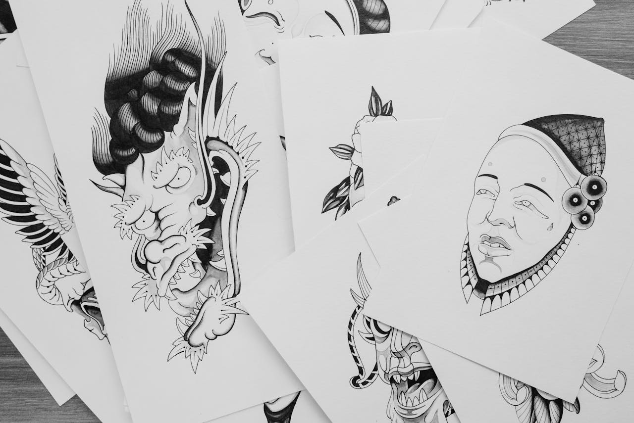 services-04 A collection of intricate black and white tattoo sketches featuring various artistic designs.